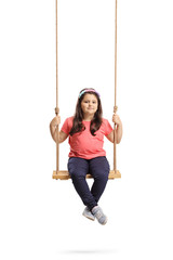 Little girl sitting on a swing