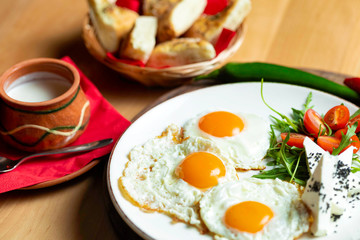 Fried eggs with cheese and tomatoes, breakfast