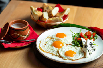 Fried eggs with cheese and tomatoes, breakfast