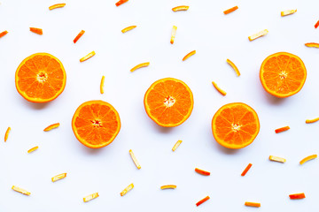 Orange with peels on white.