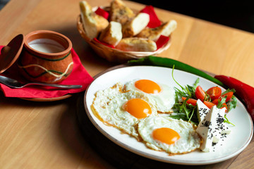 Fried eggs with cheese and tomatoes, breakfast