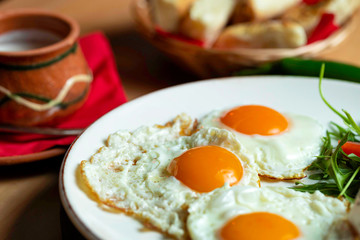 Fried eggs with cheese and tomatoes, breakfast