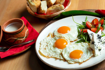 Fried eggs with cheese and tomatoes, breakfast