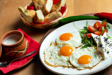 Fried eggs with cheese and tomatoes, breakfast