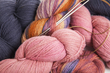 Pink, gray, multicolored yarn of wool in bundles for hand knitting, hand-painted in beautiful colors