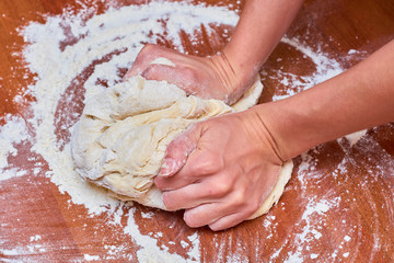 Dough for pizza on the wooden table, close-up. Dough for pizza.