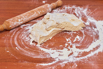 Dough for pizza on the wooden table, close-up. Dough for pizza.