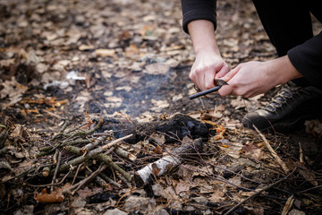 A man makes a fire with a flint