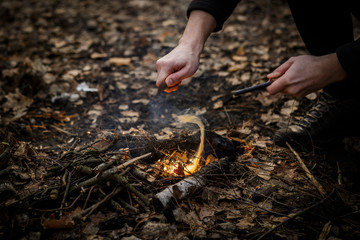 A man makes a fire with a flint