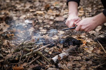 A man makes a fire with a flint