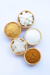 Various types of sugar on white.