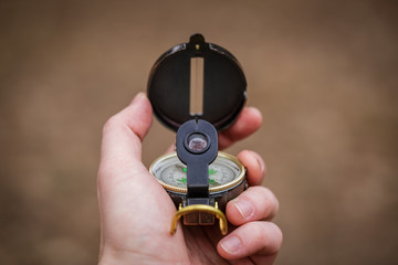 man wathing compass holding in his hands