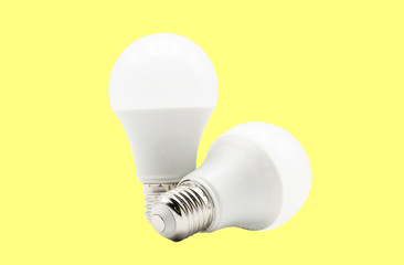 Close up of 2 LED white light bulb isolated on yellow background. Clipping path -Image.