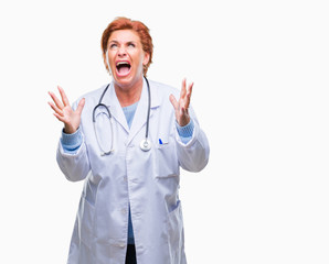 Senior caucasian doctor woman wearing medical uniform over isolated background crazy and mad shouting and yelling with aggressive expression and arms raised. Frustration concept.