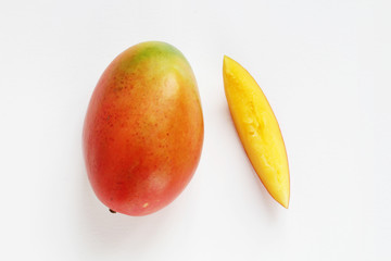 red mango with slice on white background