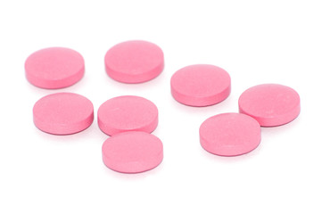 Tablets of pink color on a white background, there is a place for text.