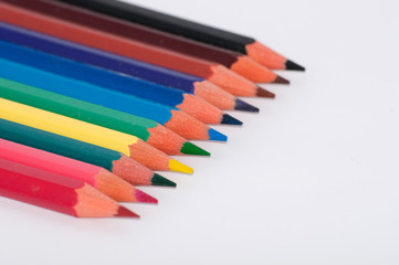 Color pencils on a white background close-up, macro, side view, with place for text.