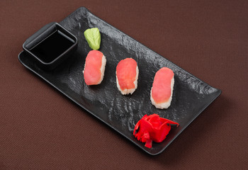 sushi on a black plate