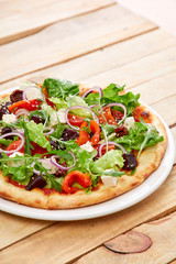 vegetarian pizza with fresh tomatoes, olives, tofu and red onion