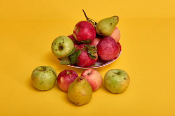 Fresh ripe pears and apples with leaves