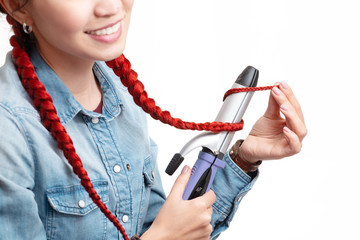 Woman uses professional Ironing tool to style her hair isolated on white background