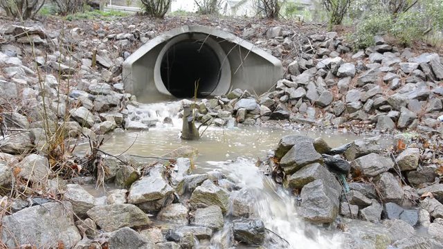 Storm water outfall outlet pipe, a conveyance method of transferring rain water from an urban site to downstream. Stones help absorb energy to prevent erosion of surrounding soils.