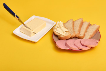 Sliced boiled sausage with bread, butter
