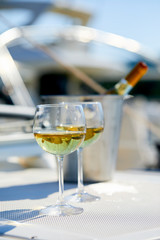 Pair of wineglasses against the yacht