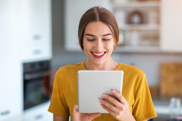 Young woman using digital tablet at home