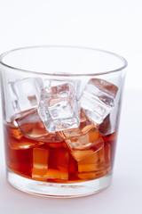 glass of whiskey with ice cubes