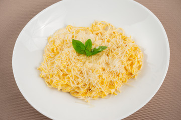 pasta with cheese in a white plate