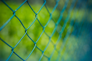 Fototapeta premium Steel fence with green background