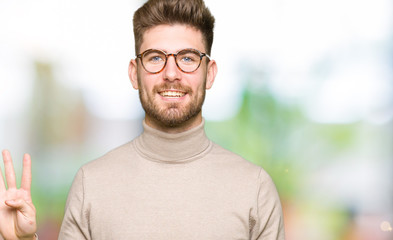 Fototapeta premium Young handsome business man wearing glasses showing and pointing up with fingers number four while smiling confident and happy.
