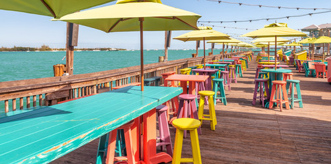 Tropical tables and benches in front of the ocean
