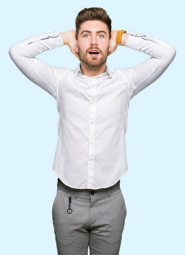 Young handsome business man Crazy and scared with hands on head, afraid and surprised of shock with open mouth