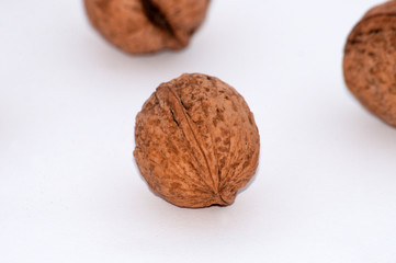 Several walnuts isolated on white background close-up macro