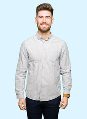 Fototapeta premium Young handsome man wearing casual shirt with a happy and cool smile on face. Lucky person.