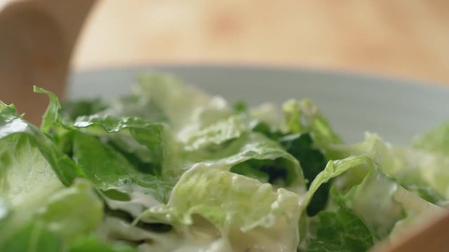 Camera follows tossing salad with dressing. Shot with high speed camera, phantom flex 4K. Slow Motion.