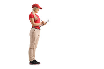 Female worker in a uniform writing on a clipboard