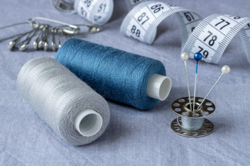 Sewing accessories and accessories for needlework in gray-blue shades.