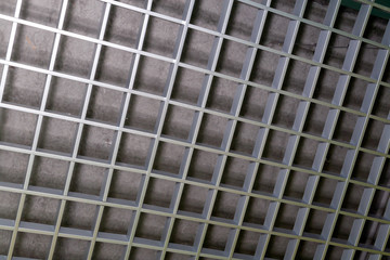 A fragment of a metal decorative lattice of gray color.