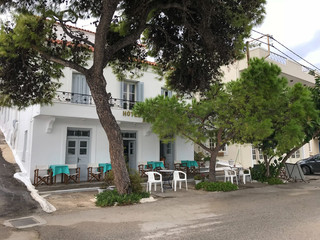 Greek tavern, restaurant, cafe on the beach. Dawn in the bay