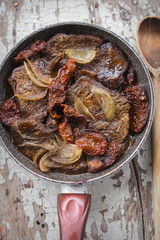 Braised beef steak in red wine with sun dried tomatoes 