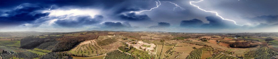 Fototapeta premium Amazing panoramic aerial view of Pontignano Charterhouse near Siena with storm approaching, Tuscany