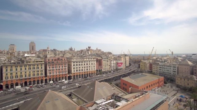 Aerial view of Geona (Genova) from bigo, the rotating panoramic tower over the celebrated acquarium. You can see cars traveling, the harbourd and the city.