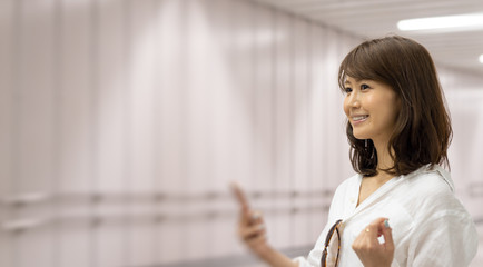 Young Asian businesswoman in the Hong Kong subway waiting for a train