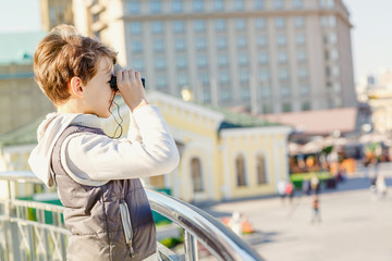 Cute young boy wandering around on city streets