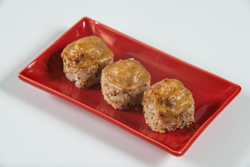 Japanese sushi rolls on a red plate. close view