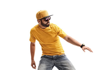 Male hipster in yellow t-shirt performing dancing moves