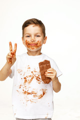 little boy with face and hands in chocolate 